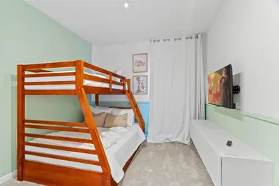 a bedroom with a bunk bed with a ladder at Luxury Paradise in Orlando Best Location in Orlando