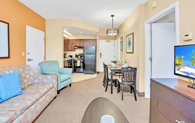 a living room with a couch and a dining room at King Suite w Pool & Hot Tub Near Disney in Orlando
