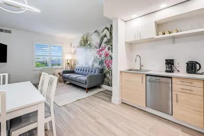 a kitchen and living room with a table and a couch at Condo close to Epic Universe and Universal Studios in Orlando