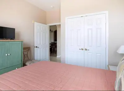 a bedroom with a bed with a pink bedspread at Making Memories At Windsor Palms Resort, Great Amenities And Much More Fun! in Kissimmee