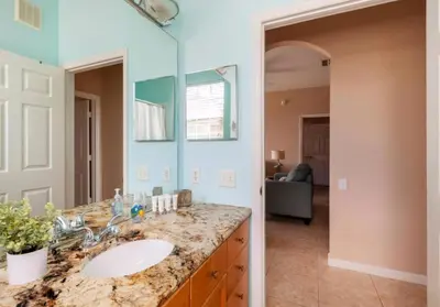 a bathroom with a sink and a mirror at Making Memories At Windsor Palms Resort, Great Amenities And Much More Fun! in Kissimmee