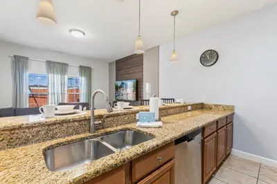 a kitchen with a sink and a counter top at 8893 Candy Palm Road in Kissimmee