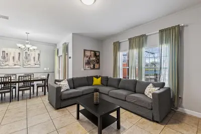 a living room with a couch and a table at 8893 Candy Palm Road in Kissimmee