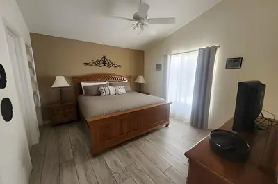 a bedroom with a bed and a flat screen tv at Lake View Pool Home near Disney and Shoppings in Kissimmee