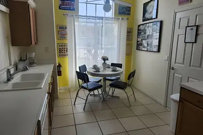a kitchen with a table and chairs and a sink at Lake View Pool Home near Disney and Shoppings in Kissimmee