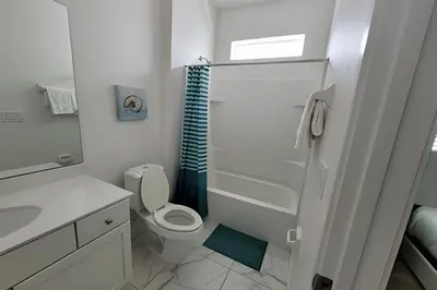 a white bathroom with a toilet and a sink at Fantastic Large Pool,Sonoma Resort in Kissimmee