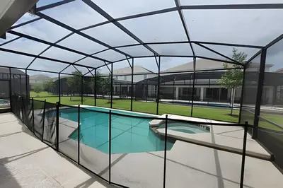 an external view of a glass house with a swimming pool at Fantastic Large Pool,Sonoma Resort in Kissimmee