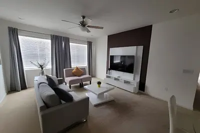 a living room with a couch and a tv at Fantastic Large Pool,Sonoma Resort in Kissimmee