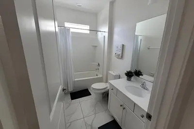 a white bathroom with a toilet and a sink at Fantastic Large Pool,Sonoma Resort in Kissimmee