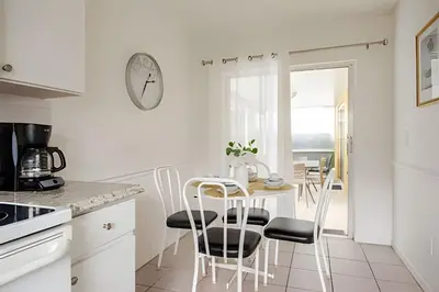 a kitchen with a table and chairs and a clock at 10 Minutes to Disney Pool Home *Renovated* in Kissimmee