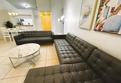 a living room with a couch and a table at Lakeside Pool Home, Games close to Disney & Malls in Kissimmee