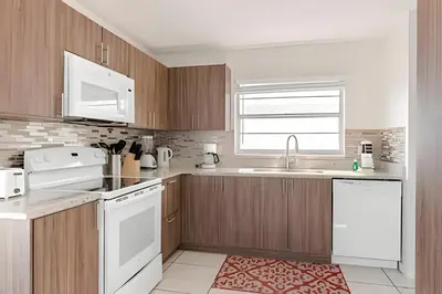 a kitchen with wooden cabinets and white appliances at Lakeside View Pool Home, close to Disney, Malls in Kissimmee