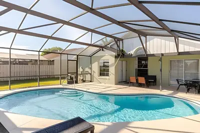 a large swimming pool with a roof over it at Lakeside View Pool Home, close to Disney, Malls in Kissimmee