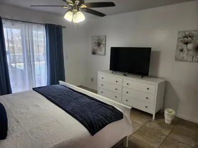 a bedroom with a bed and a television on a dresser at Central Location Lakeview Pool Villa near Disney in Kissimmee
