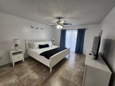 a bedroom with a bed and a ceiling fan at Central Location Lakeview Pool Villa near Disney in Kissimmee