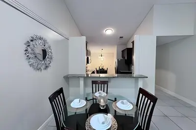 a dining room and kitchen with a table and chairs at 10 Minutes to Disney! Pool Hom, Large Backyard in Kissimmee