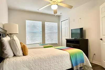 a bedroom with a bed and a ceiling fan at Bella Vida Resort Pool Home near Disney in Kissimmee
