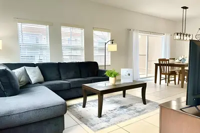 a living room with a couch and a table at Bella Vida Resort Pool Home near Disney in Kissimmee