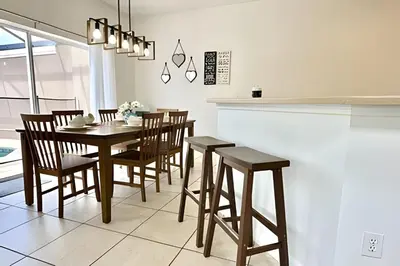 a dining room with a table and chairs at Bella Vida Resort Pool Home near Disney in Kissimmee