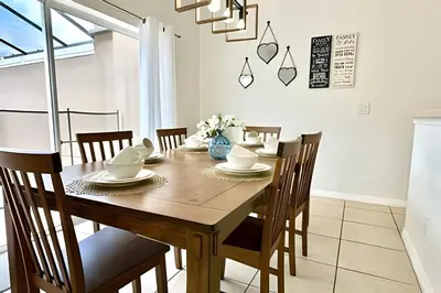 a dining room with a wooden table and chairs at Bella Vida Resort Pool Home near Disney in Kissimmee