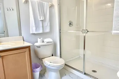 a bathroom with a shower and a toilet and a sink at Bella Vida Resort Pool Home near Disney in Kissimmee