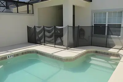 a swimming pool with a fence around it at Storey Lake Private Pool Home Near Disney in Kissimmee
