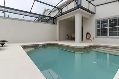a swimming pool in a house with a glass ceiling at Storey Lake Private Pool Home Near Disney in Kissimmee