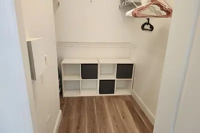a small room with white walls and wooden floors at Runaway Beach Club Condo near Disney in Kissimmee