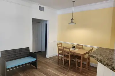 a kitchen and dining room with a table and chairs at Runaway Beach Club Condo near Disney in Kissimmee