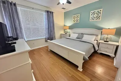 a bedroom with a bed and a flat screen tv at Vista Cay Spacious Convention Center/Disney in Orlando