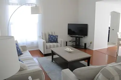 a living room with white furniture and a tv at Premium Pool Villa Centrally Located near Disney in Kissimmee