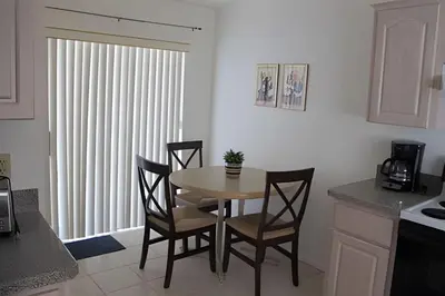 a kitchen with a table and chairs in a room at Premium Pool Villa Centrally Located near Disney in Kissimmee