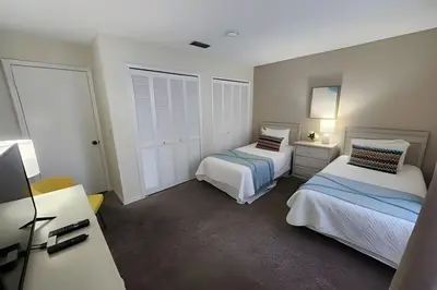 a bedroom with two beds and a dresser in it at Huge Lot, Private Pool Home Centrally Located in Kissimmee