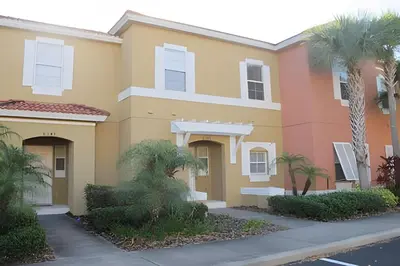 a building with palm trees in front of it at Encantada Resort, Pool, close to Disney in Kissimmee