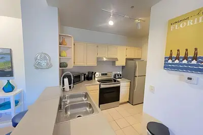 a kitchen with a sink and a stove top oven at Cozy & Bright Condo in Legacy Dunes near Disney in Kissimmee