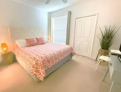 a bedroom with a bed and a desk and a window at Cozy & Bright Condo in Legacy Dunes near Disney in Kissimmee