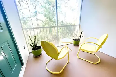 three chairs and a table in front of a window at Cozy & Bright Condo in Legacy Dunes near Disney in Kissimmee