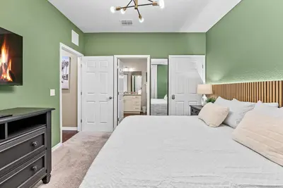 a bedroom with green walls and a bed and a fireplace at NEW 4Bedrooms At LucayaClose to Disney in Kissimmee