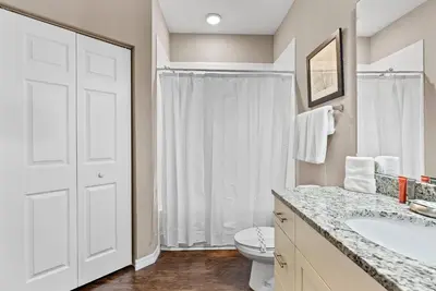 a white bathroom with a sink and a toilet at NEW 4Bedrooms At LucayaClose to Disney in Kissimmee