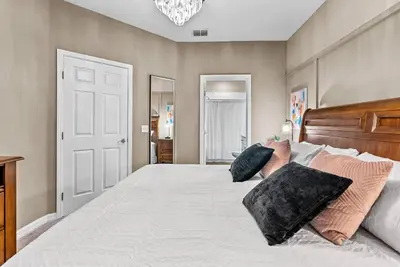 a bedroom with a large white bed with pillows at NEW 4Bedrooms At LucayaClose to Disney in Kissimmee