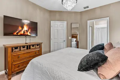 a bedroom with a bed with a fireplace on the wall at NEW 4Bedrooms At LucayaClose to Disney in Kissimmee