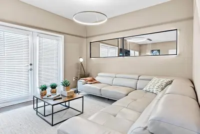 a living room with a white couch and a table at NEW 4Bedrooms At LucayaClose to Disney in Kissimmee