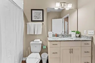 a bathroom with a toilet and a sink and a mirror at NEW 4Bedrooms At LucayaClose to Disney in Kissimmee
