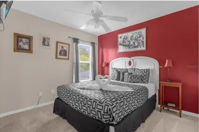 a bedroom with a bed with two swans on it at 2767LKD-Emerald Island Resort home in Kissimmee