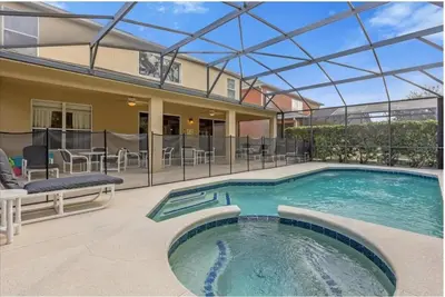 a swimming pool with a glass roof on a house at 2767LKD-Emerald Island Resort home in Kissimmee