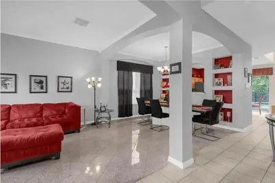 a living room with a red couch and a table at 2767LKD-Emerald Island Resort home in Kissimmee