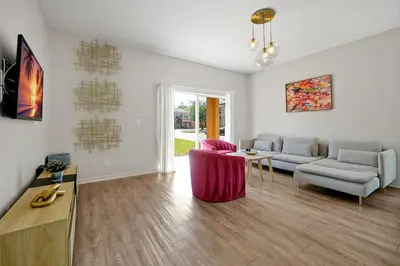 a living room with a couch and a table at Resort Access and Great Location in Orlando