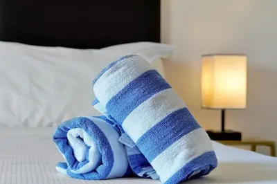 a rolled up towel on top of a bed at Resort Access and Great Location in Orlando