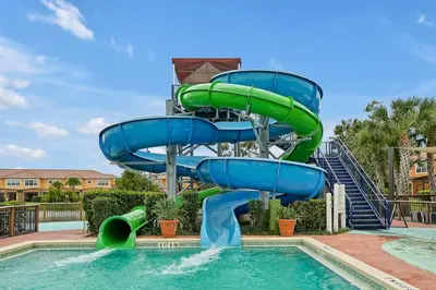 a water slide in a pool at a resort at Resort Access and Great Location in Orlando