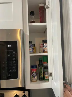 a kitchen cupboard with spices and a microwave at Private 1 Bed 1 Bath Orlando Oasis Shopping and Parks Nearby in Orlando